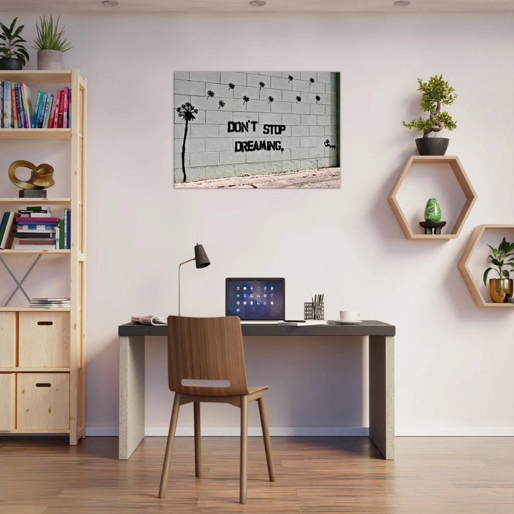 Banksy motivational canvas wall art displayed in a modern home office.