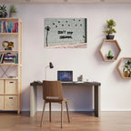 Banksy motivational canvas wall art displayed in a modern home office.
