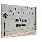 Angled close-up of the Banksy Don't Stop Dreaming stretched canvas and side edge.