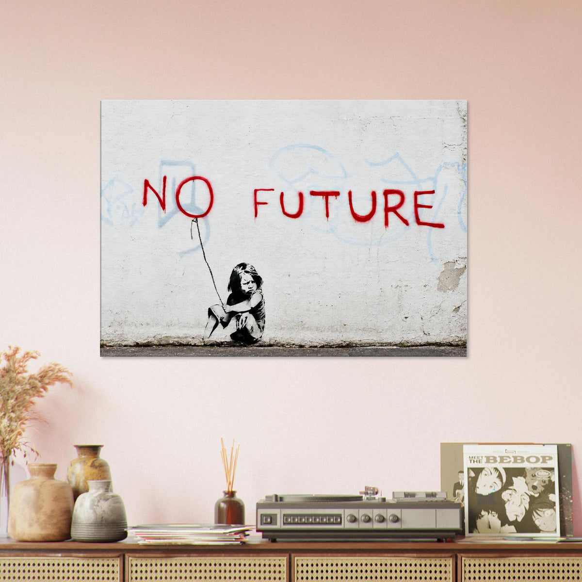 Banksy No Future canvas wall art above a wooden console in a warm modern living room with neutral decor
