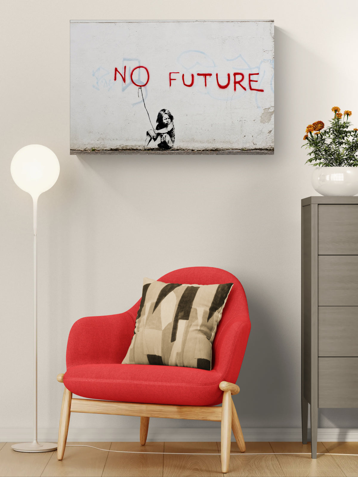 Banksy No Future graffiti canvas displayed above a red armchair in a bright contemporary interior