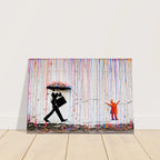 Front display of Rainbow Rain canvas wall art with umbrella man, orange child and colourful paint drips