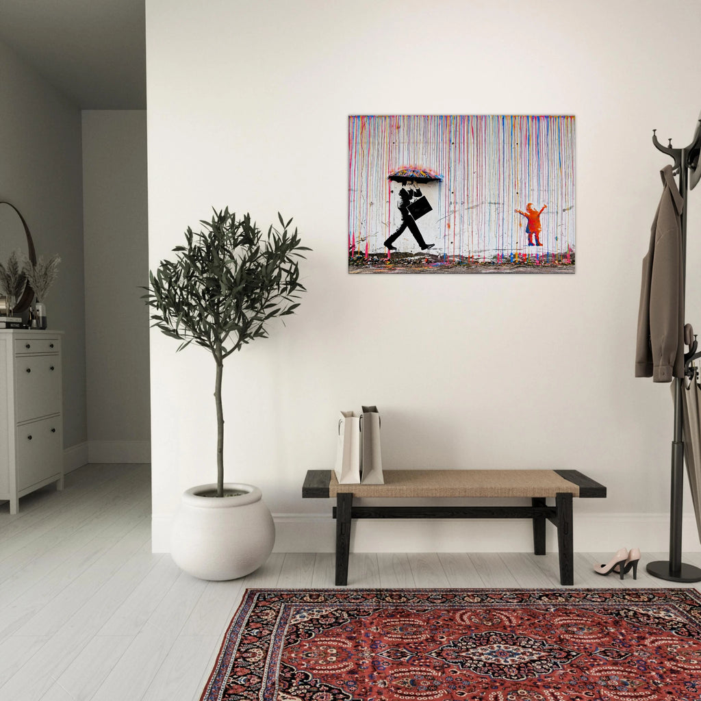 Banksy Rainbow Rain canvas above a grey sofa in a modern living room with a patterned rug