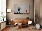 Banksy Rainbow Rain canvas above a wooden sideboard in a warm modern living room with neutral walls